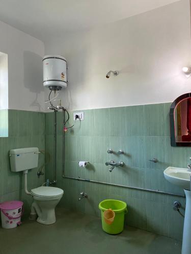 a bathroom with a toilet and a sink at Hotel Galaxy Ladakh in Leh