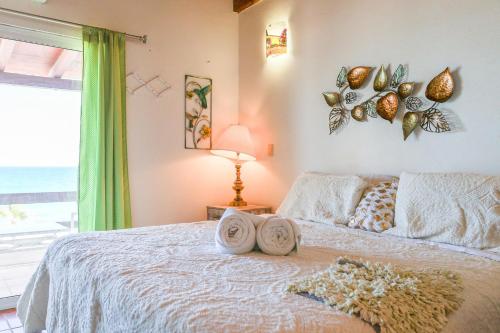 a bedroom with a bed with towels on it at Paradise Villas #16 in Playa Encanto