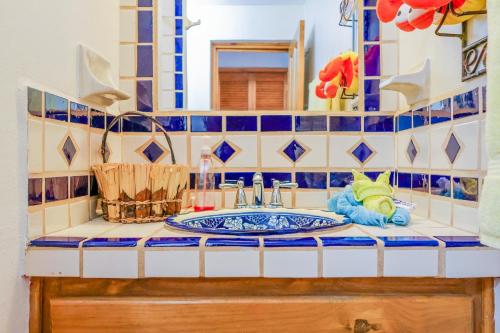 a bathroom with a sink and a mirror at Paradise Villas #16 in Playa Encanto