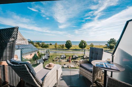 a view of the ocean from the balcony of a house at Hotel Königslinie in Sassnitz