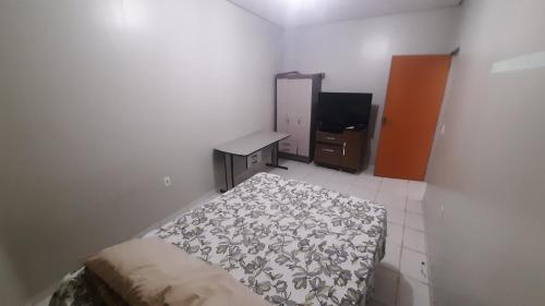 a bedroom with a bed and a desk in it at Apt 402 Ed Nilson Pimentel in Barreiras