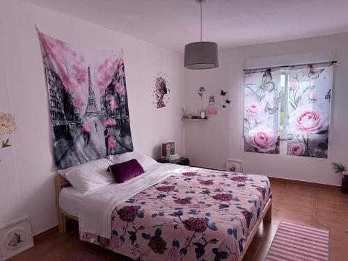 a bedroom with a bed and two windows with flowers at Traditional Peniche House in Peniche
