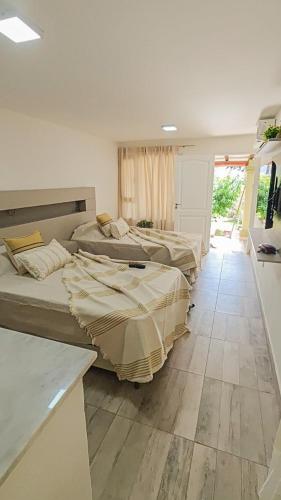 a room with three beds in a room at Suite de Lujo Castañitas in Tafí del Valle