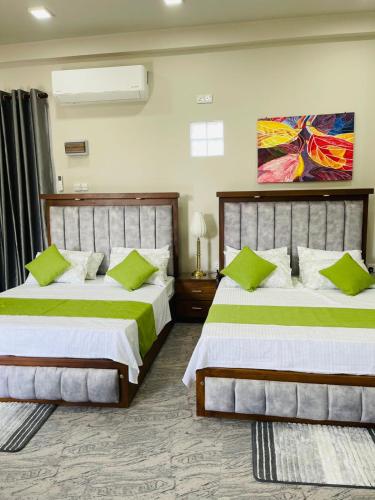 a bedroom with two beds and a painting on the wall at Horizon in Katunayaka