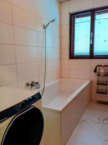 a bathroom with a bath tub and a shower at Gästehaus Stolzalpe in Stolzalpe