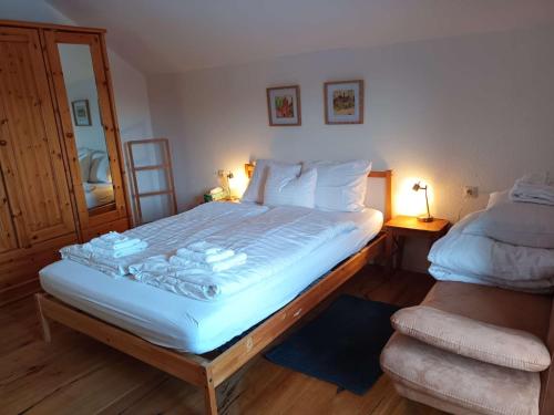 a bedroom with a large white bed with two lamps at Gästehaus Stolzalpe in Stolzalpe
