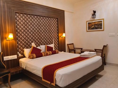 a bedroom with a large bed in a room at Grand Milestone in Mysore