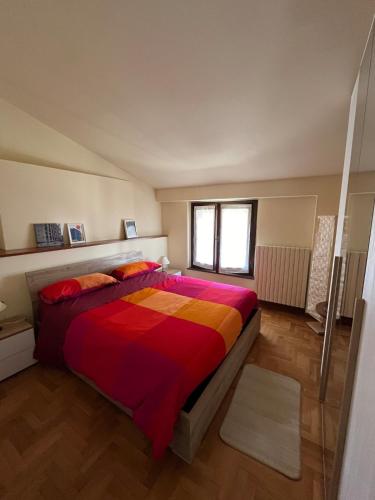 a bedroom with a large bed with a colorful blanket at CasaLea in Calcinate