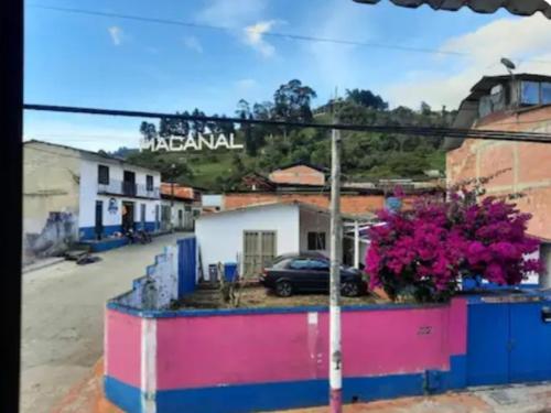 a street sign in a small town with a car at Apartamento Macanal in Macanal