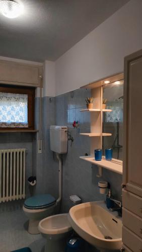 a bathroom with a toilet and a sink at Casa Vallina - Garden & Mountain View in Castion