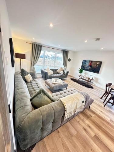 a large living room with a large couch at Perceval Road, Stornoway Town in Stornoway