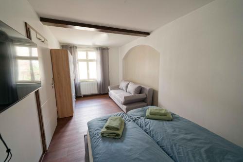 a small bedroom with a bed and a couch at Spreezauber in Lübbenau