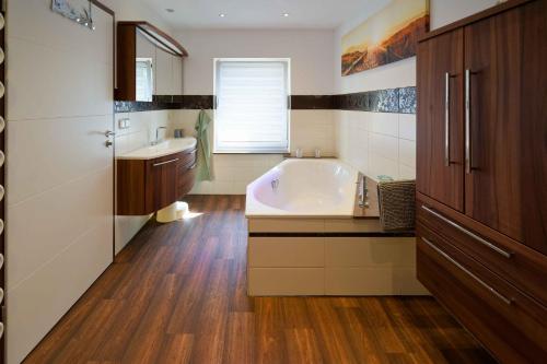 a bathroom with a large tub and a sink at Spreezauber in Lübbenau