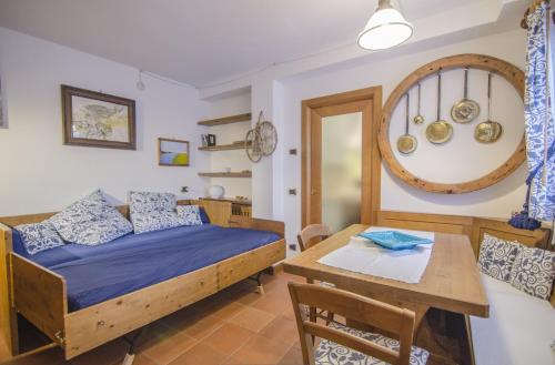 a bedroom with a bed and a dining table at Un angolo di relax sulle Dolomiti ampezzane in Cortina dʼAmpezzo