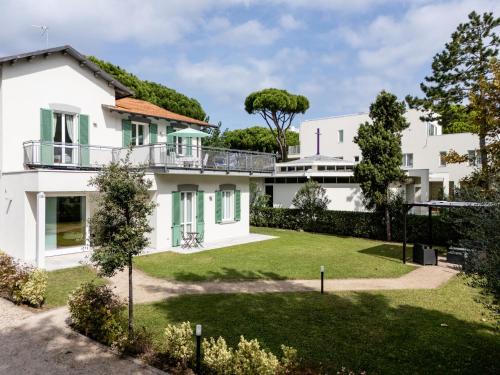 an exterior view of a white house with a yard at Le Sabbie B&B - Camere in villino a 50mt dal mare in Riccione