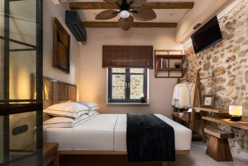 a bedroom with a bed and a ceiling fan at Diastar Boutique in Heraklio