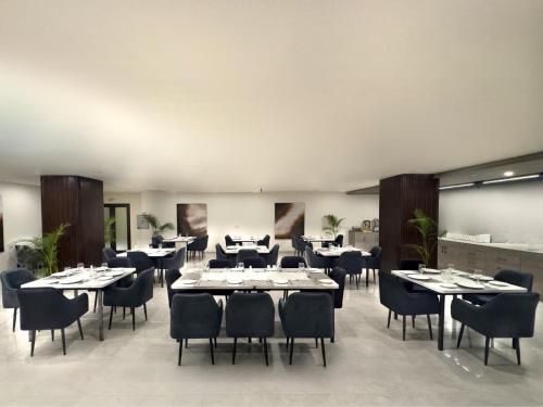 a dining room with tables and chairs in a room at Hotel One Vogue Mall 35 Rawalpindi in Rawalpindi