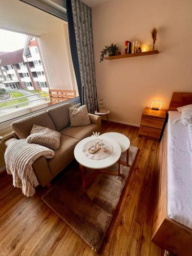 a living room with a couch and a table at Trafalgar Apartment 133 in Cuxhaven