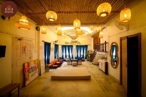 a living room with a couch and chairs and lights at Ghotul Hostel & Homestay in Guwahati
