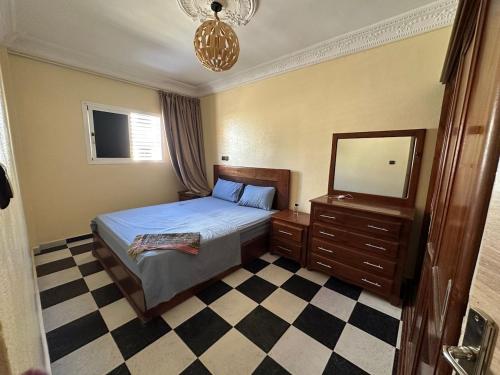 a bedroom with a bed and a dresser and a mirror at Amazing apartment with traditional touch in Taskala
