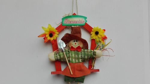 a christmas ornament of a woman with flowers on a wall at Cabaña El Ingenio in El Ingenio