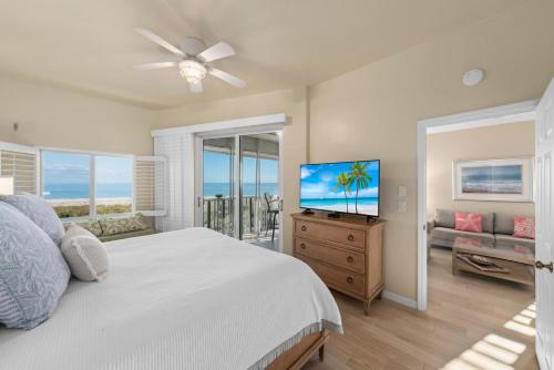 a bedroom with a bed and a flat screen tv at Shell Island Beach Club #5D in Sanibel