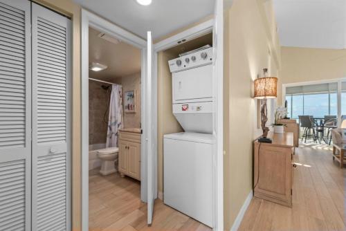 a kitchen with a refrigerator and a sink in a room at Shell Island Beach Club #5D in Sanibel
