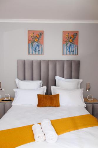 a bedroom with a large bed with white and orange pillows at Selamu Self Catering in Walvis Bay