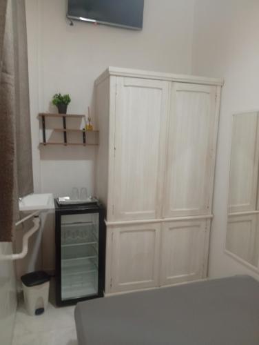 a bedroom with a large white cabinet in a room at Cantinho in Rio de Janeiro