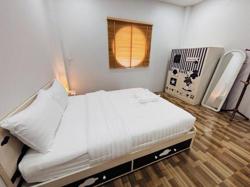 a bedroom with a large white bed with a window at AAA villa Aonang Krabi in Ao Nang 
