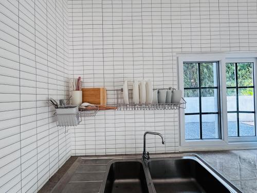 a kitchen with a sink and a window at AAA villa Aonang Krabi in Ao Nang 