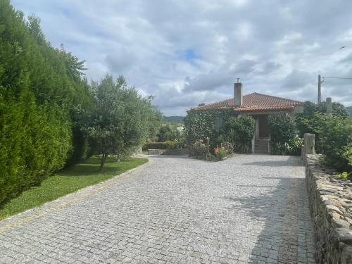 a cobblestone driveway in front of a house at Quinta do Sobrado in Braga