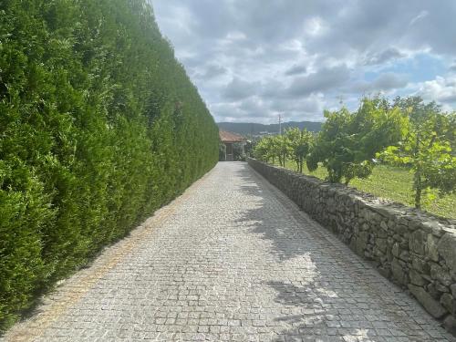 a stone path next to a stone wall at Quinta do Sobrado in Braga