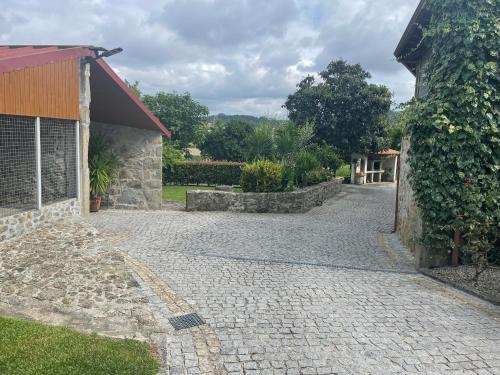 a cobblestone driveway next to a building at Quinta do Sobrado in Braga
