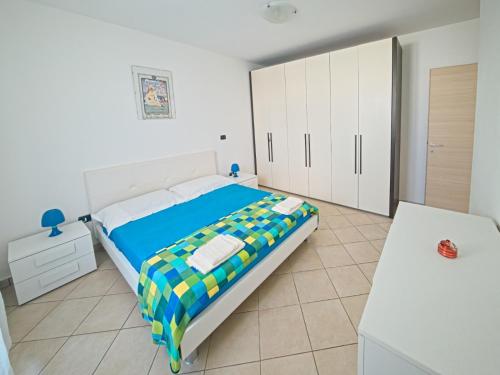a bedroom with a bed and white cabinets at Residence Lucrezia in Nardò