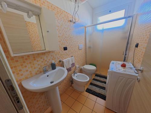 a bathroom with a sink and a toilet at Residence Lucrezia in Nardò