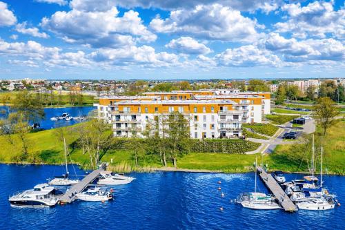 a group of boats are docked in a marina at ApartView - ogród, taras, winda, widok na Jeziorak, Netflix i Max, parking in Iława