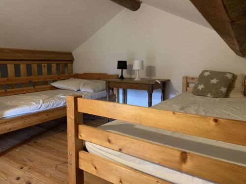 a bedroom with two bunk beds and a desk at Maison de caractère in Saint-Vert