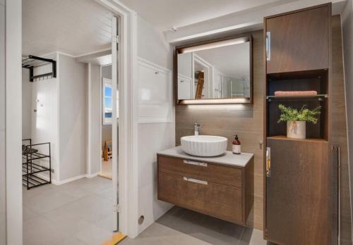 a bathroom with a sink and a mirror at Panoramic View of Voss - Private Cabin & Patio in Vossevangen