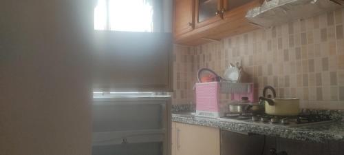 a kitchen with a stove and a counter top at Appartement à Sable d'or tanger in Tangier