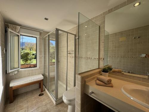a bathroom with a shower toilet and a sink at Casa Los Campones en Asturias VV-3585-AS in Nava