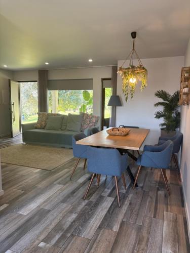 a dining room with a wooden table and blue chairs at Casa D' Almeidas in Amares