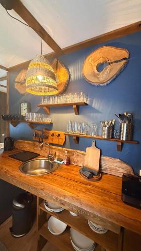 a kitchen with a wooden counter with a sink at Camping Bušas in Saulkrasti