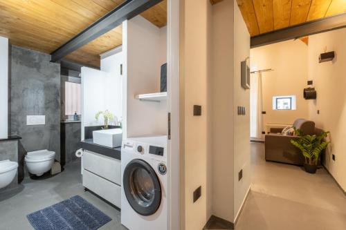 a bathroom with a washer and dryer in it at Via Roma 106 Apartment in Sassari