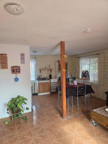a kitchen and living room with a table and chairs at Margaret in Combarbalá
