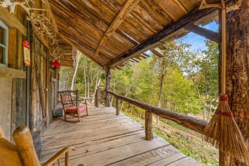 a porch of a cabin with a chair on it at Squatter's Cabin (Off-Grid): Includes 1-UTV in Jasper