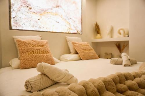 a bedroom with two beds with towels on the floor at Welcome to Hidden Spa in Wissous
