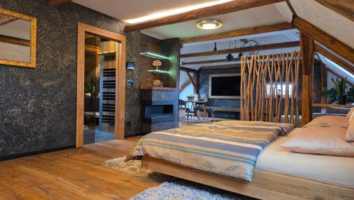 a bedroom with a large bed and a dining room at Apartmány Wake up Coffee in Proseč