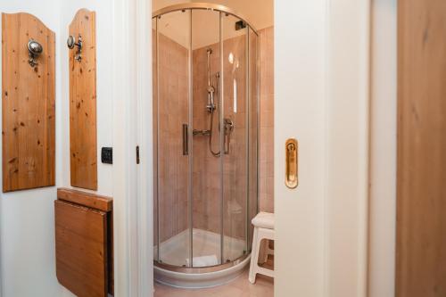 a bathroom with a shower and a toilet at Hotel Oasi in Cortina dʼAmpezzo