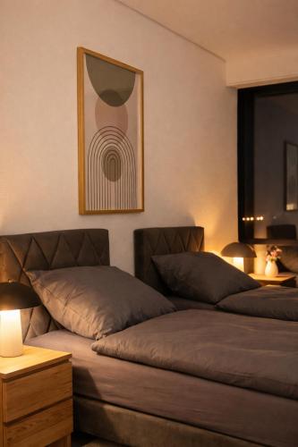 a bedroom with two beds and a picture on the wall at Monteur- und Ferienunterkunft Ludwigsfelde in Ludwigsfelde